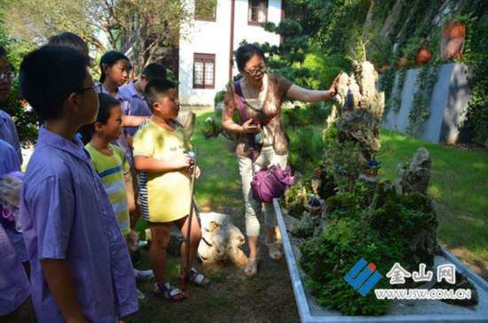 镇江城管送关爱 带环卫工子女看盆景展